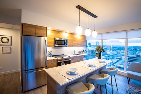 A modern kitchen with a dining table and chairs.