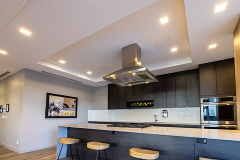 A modern kitchen with a stainless steel range hood.