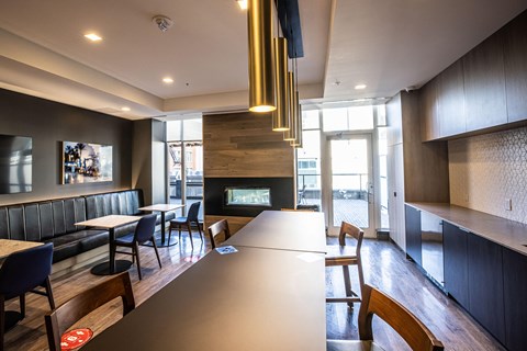 A modern dining room with a long table and chairs.