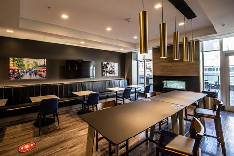 A modern dining room with a long table and chairs.
