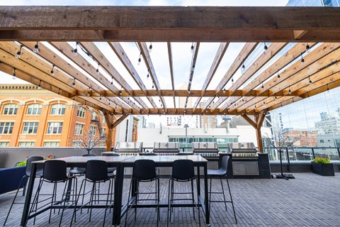 A wooden patio with a table and chairs.