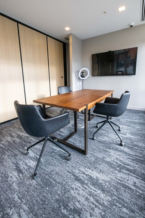 A conference room with a wooden table and two chairs.