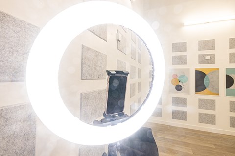 A round mirror with a light reflection in the middle.