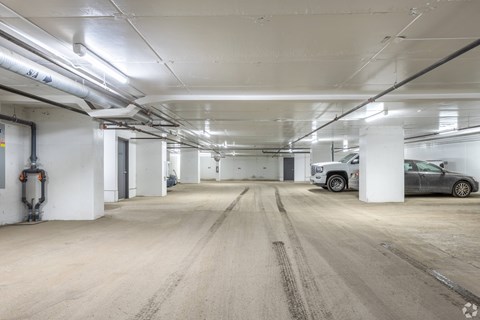 A large, empty parking garage with a truck parked in the distance.