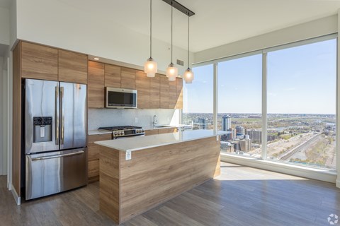 A modern kitchen with a view of the city.