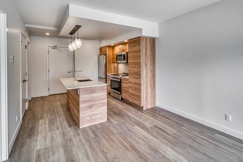 A kitchen with a wooden island and a white refrigerator.