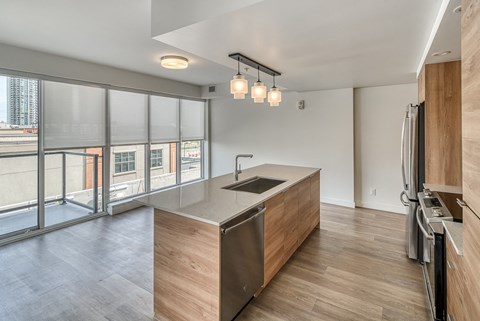 A modern kitchen with wooden cabinets and stainless steel appliances.