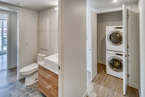 A white washing machine is in a doorway.