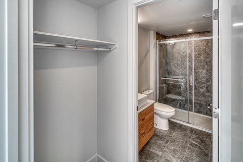 A white bathroom with a walk in shower and toilet.