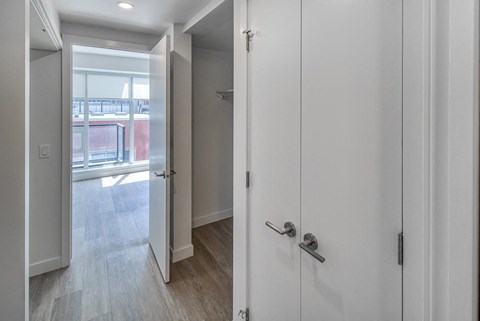 A white door with a silver handle is open.