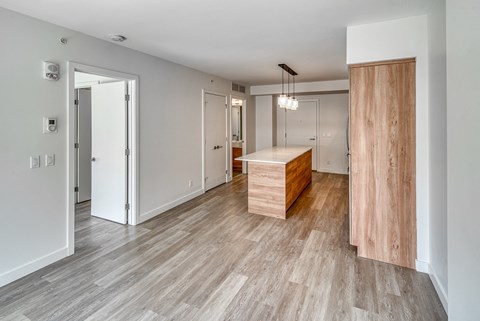 A room with a wooden floor and a white wall.
