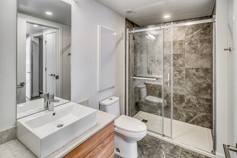 A white sink is on a countertop in a bathroom.