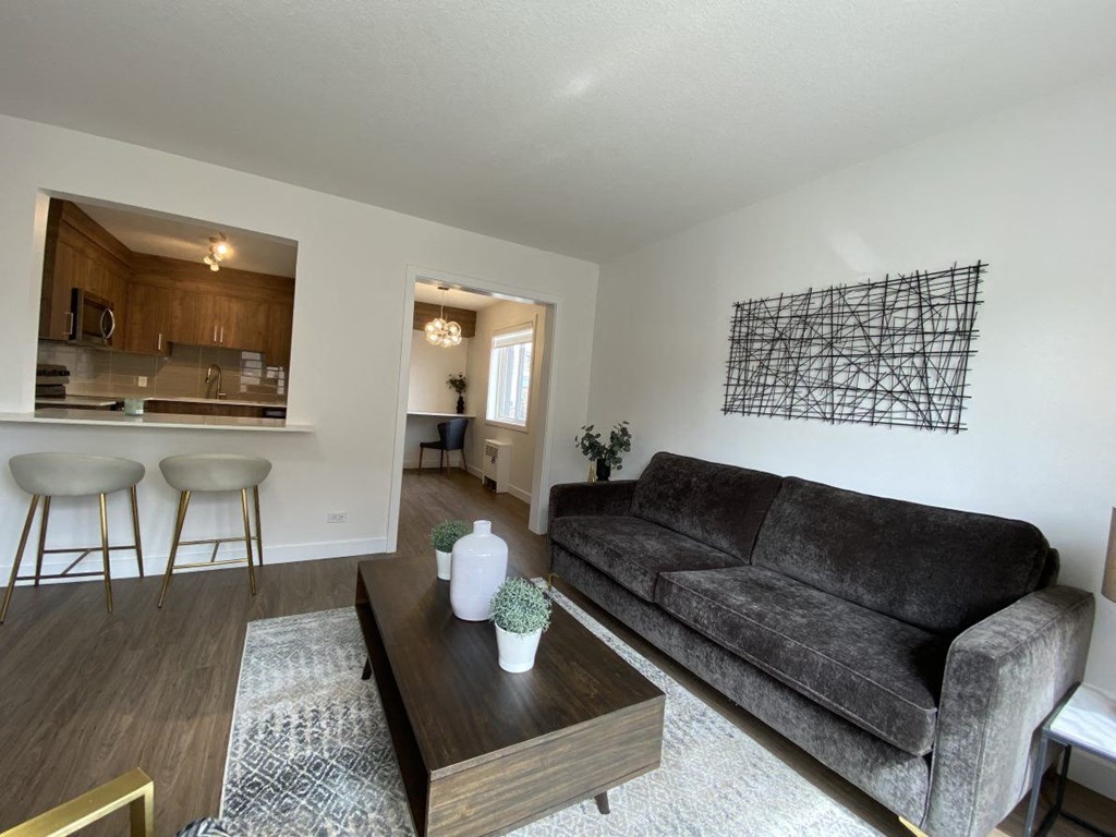 A living room with a grey couch and a wooden table.
