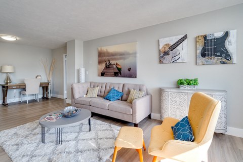 a living room with a couch and chairs and a table