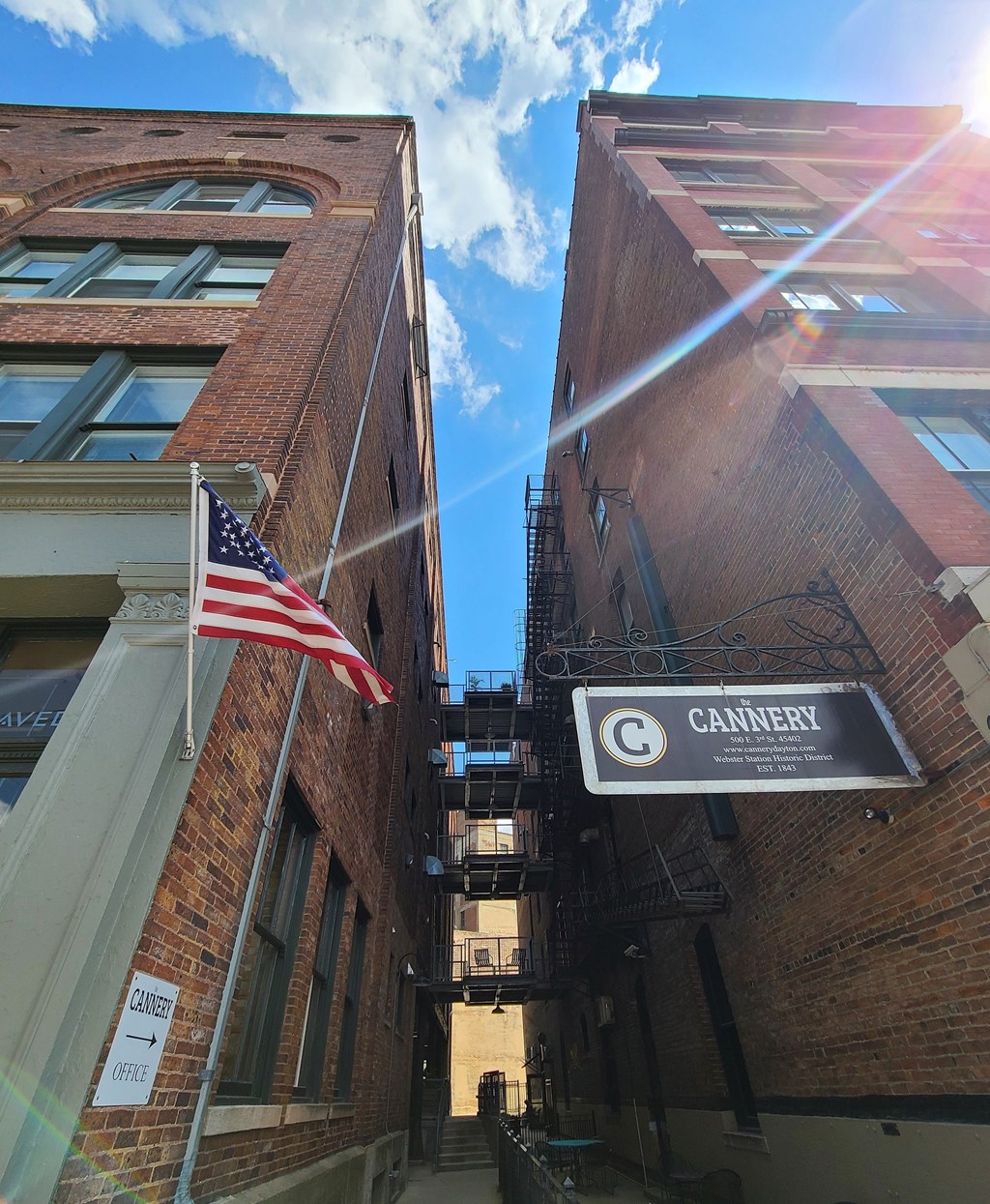 A narrow alley with a Cannery sign on the right.