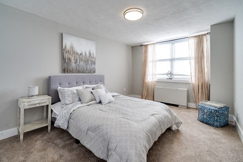 a bedroom with a large bed and a window