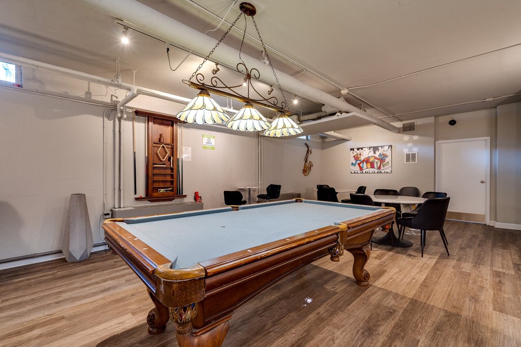 Pool table in the resident lounge with a table and chairs in the background at The View of Dayton Towers