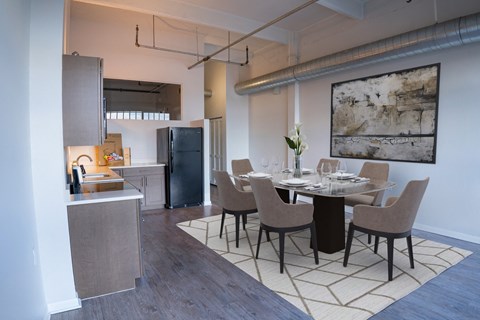 a dining room and kitchen with a table and chairs