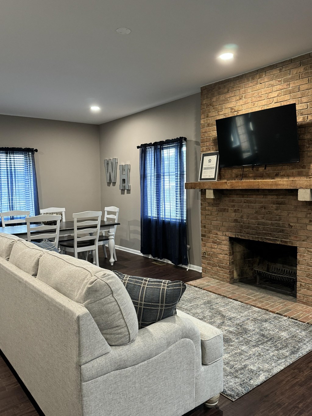 a living room with a couch and a table and a fireplace