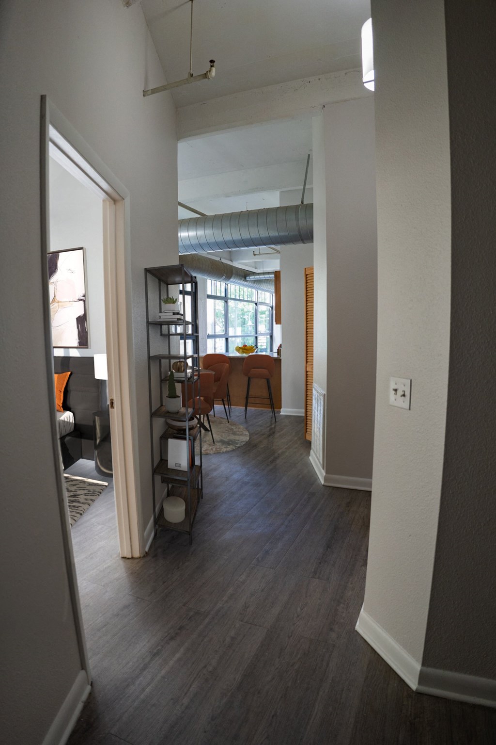 A view of the dining room from the living room with hardwood-style flooring at Dayton, OH apartments
