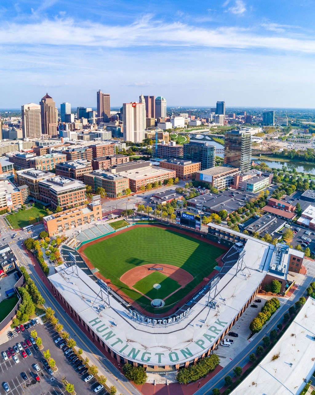an aerial view of a baseball stadium with a city in the background