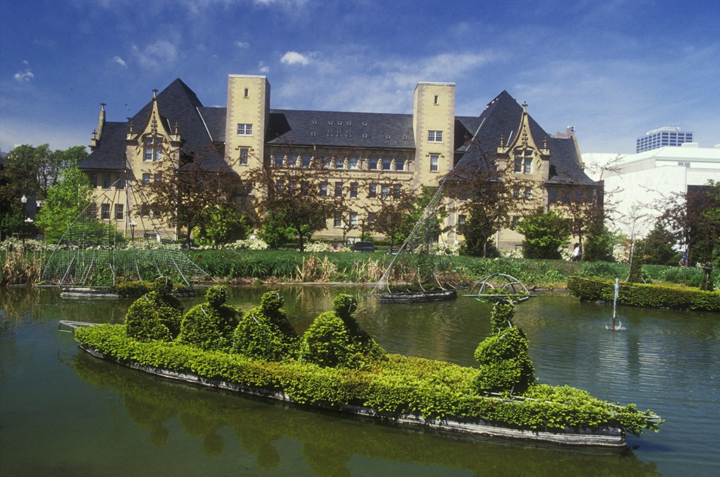 a castle in the middle of a lake with boats in the water