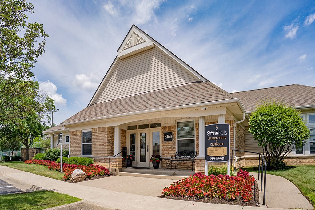 A house with a sign that says "StoneFalls" in front of it.