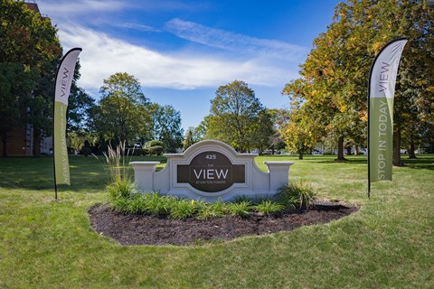 A sign that says "VIEW" is in the middle of a grassy area.