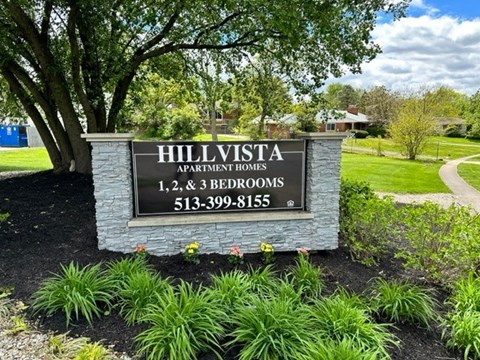 A sign for Hillvista Apartment Homes with 1, 2, and 3 bedrooms.
