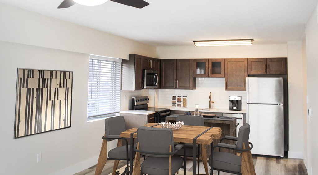 A modern kitchen with a dining table and chairs.