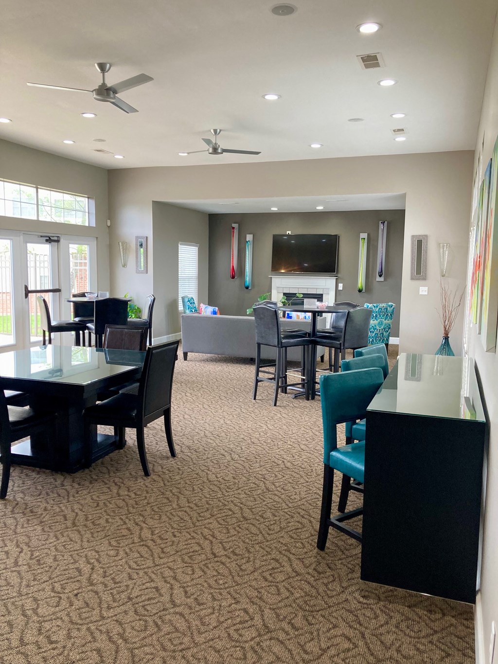 a dining room and living room with tables and chairs and a television