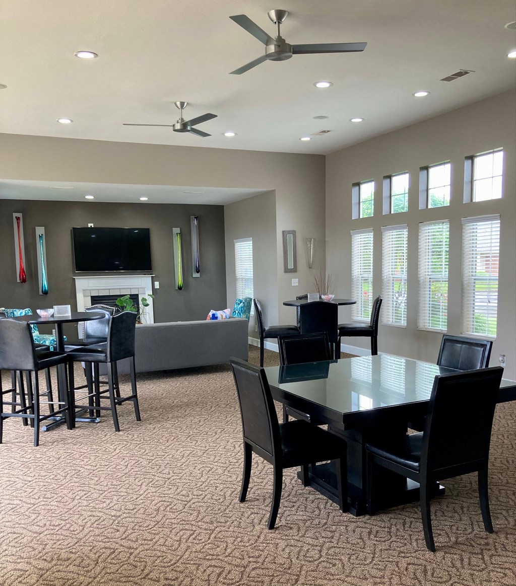 a dining room and living room with a table and chairs