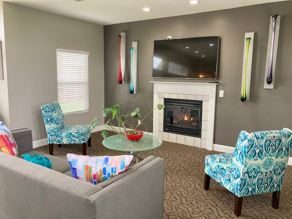 a living room with a fireplace and a television