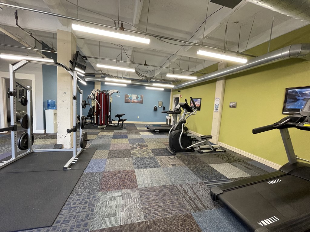 Fitness center at St. Clair Lofts with treadmills and other exercise equipment