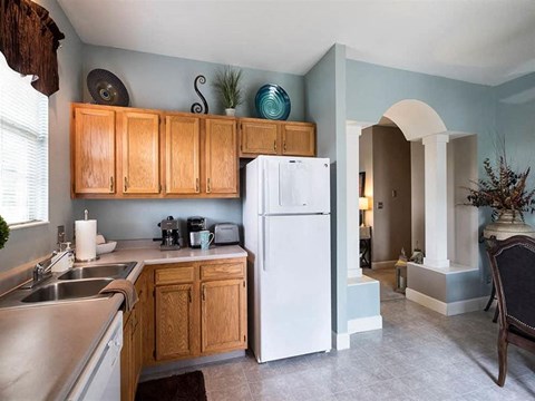 a kitchen with a refrigerator and a sink