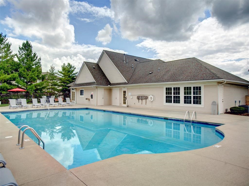 a swimming pool in front of a house