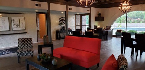 a living room with a red chair and a table