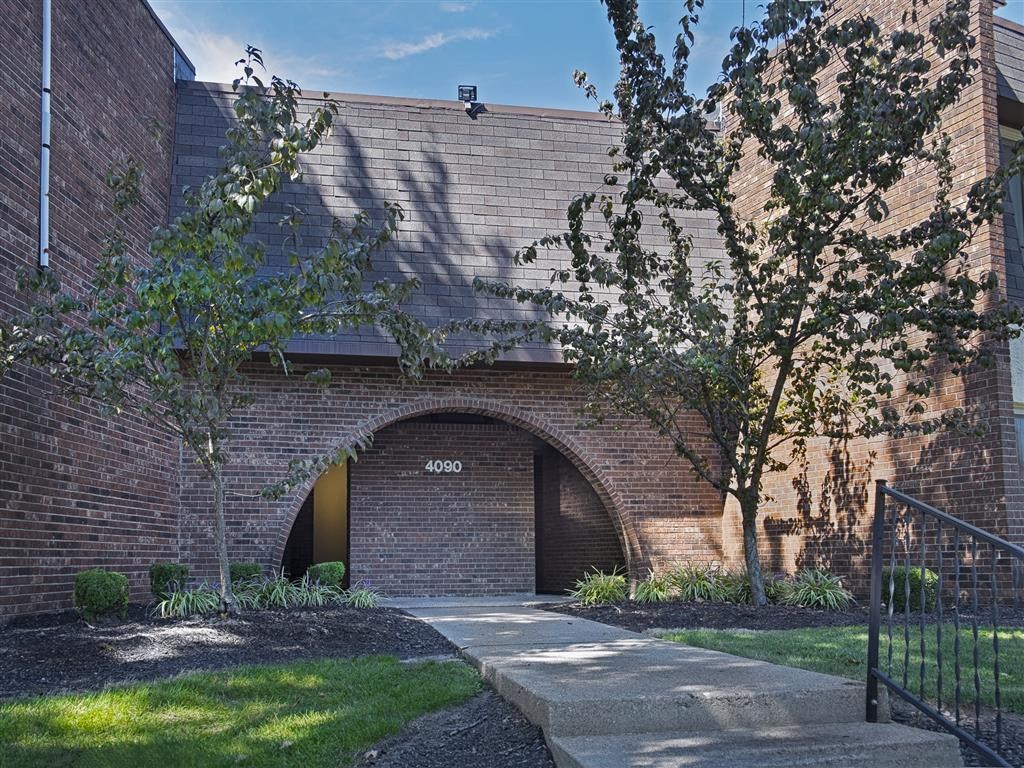 the front of a brick building with a garage door