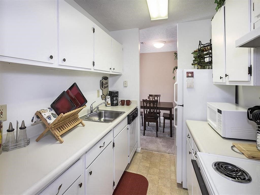 a kitchen with a sink and a stove and a refrigerator