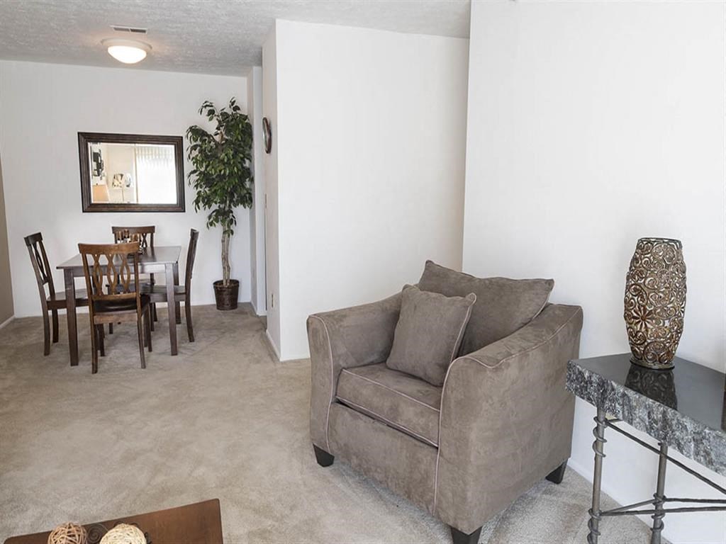 a living room and dining room with a couch and a table