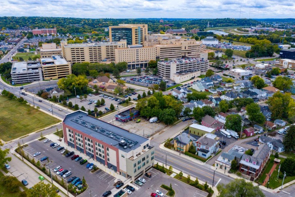 an aerial view of a city with buildings and cars