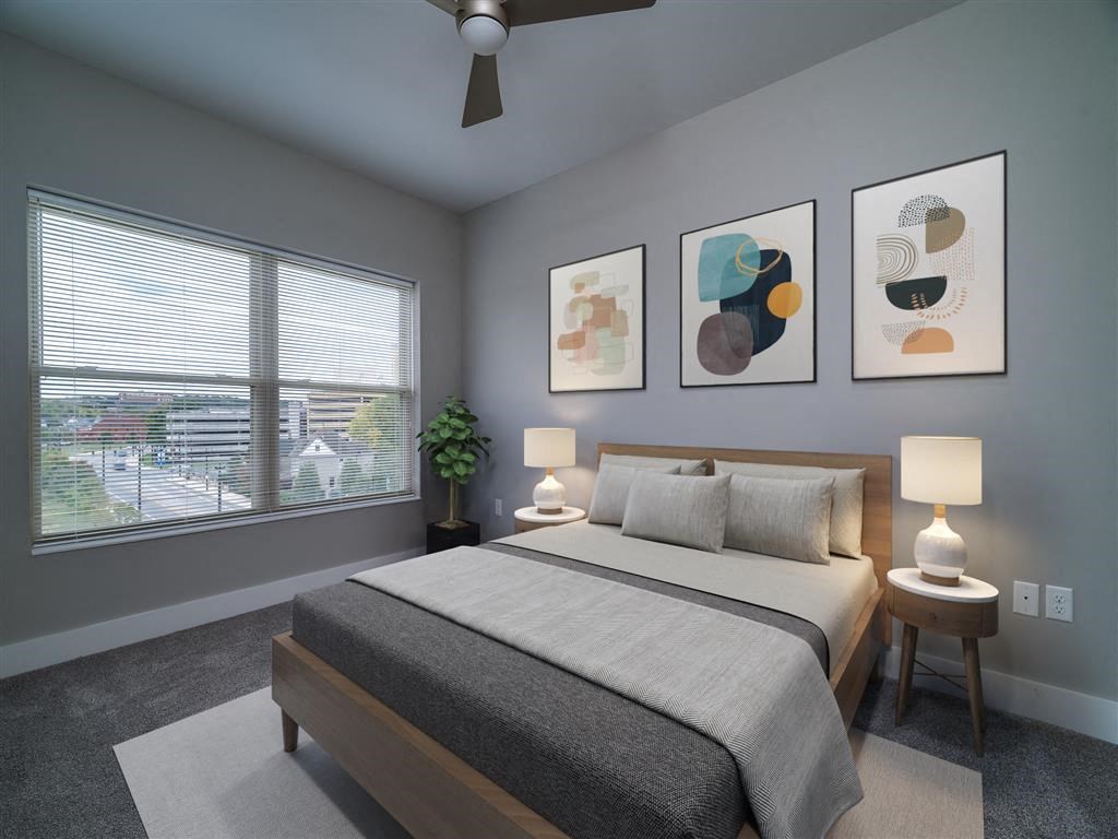 a bedroom with a bed and a large window