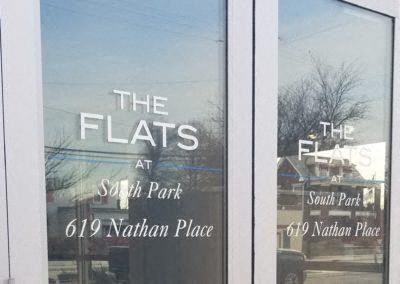 a store front window with the flats at south part and the flat at south park