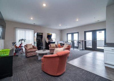 a living room with couches and chairs and a television