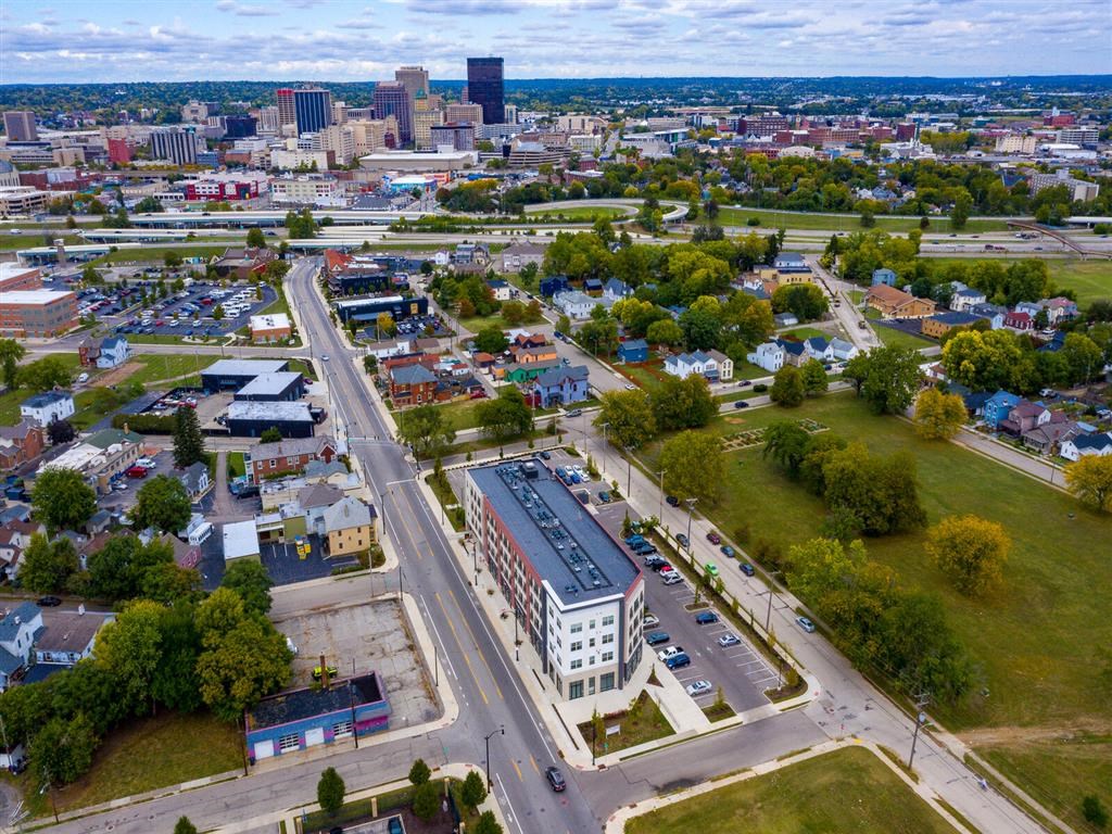 an aerial view of a city with a building and a highway