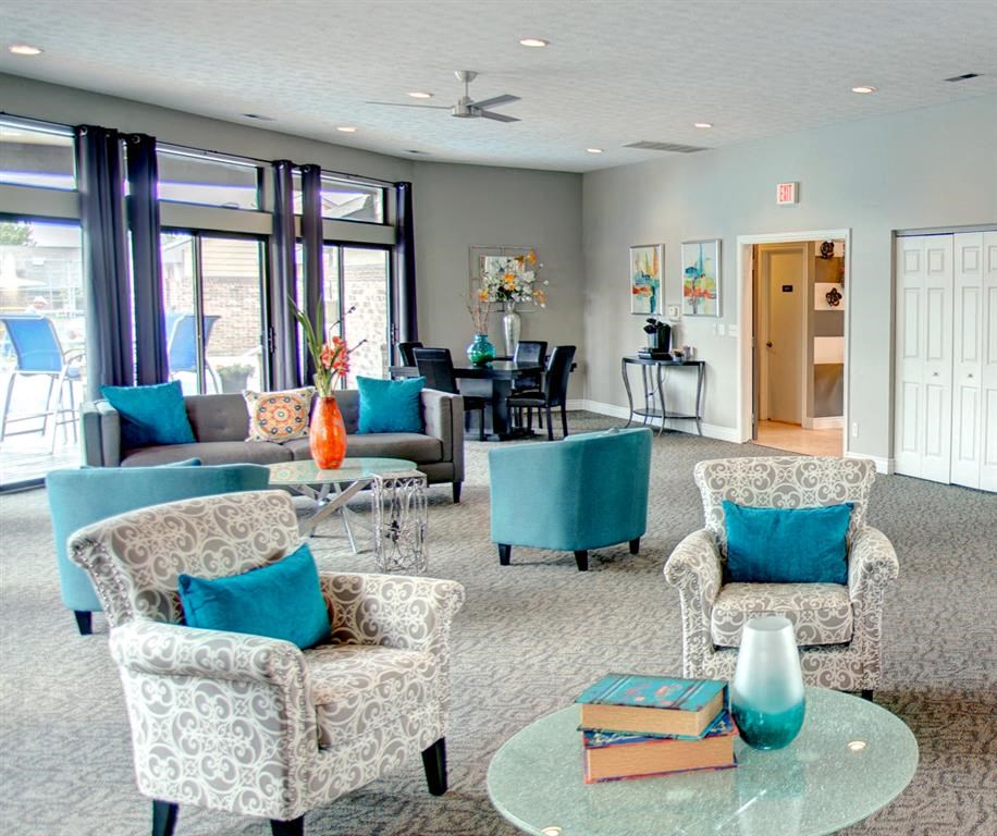 a large living room with blue and white furniture