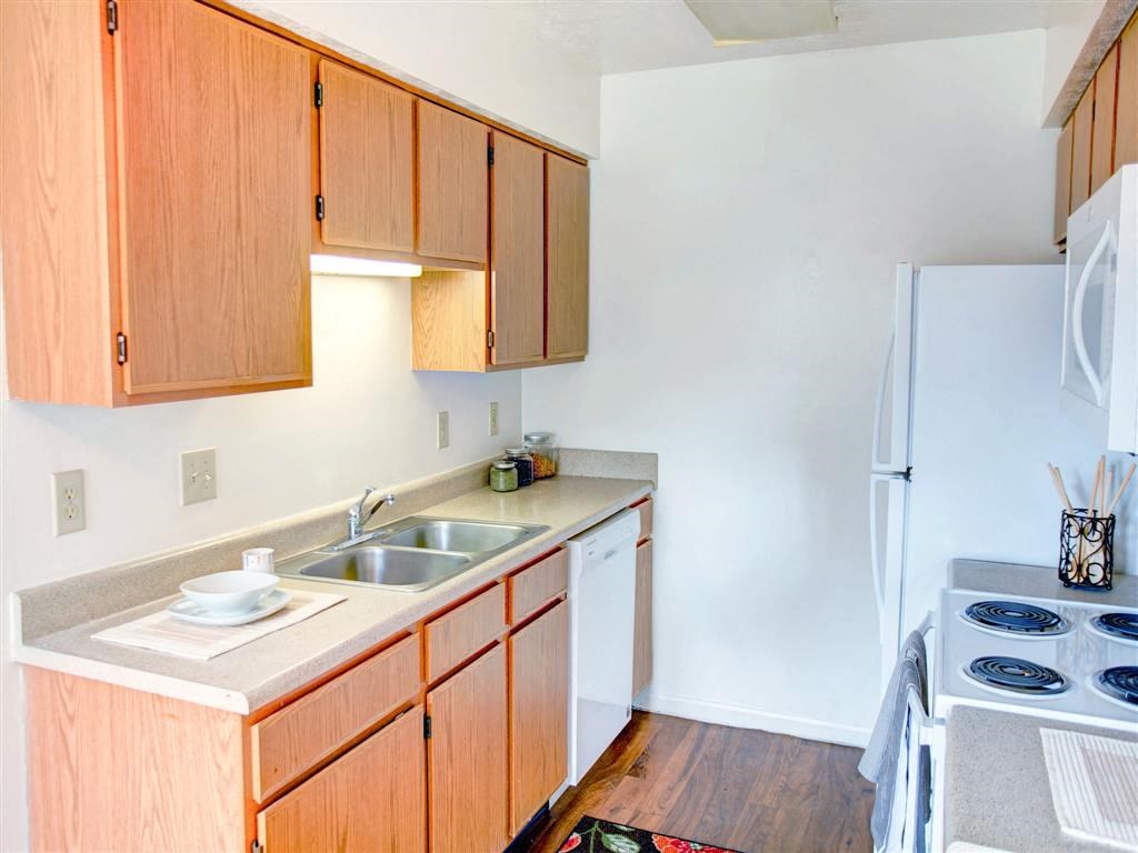 a kitchen with a stove sink and refrigerator