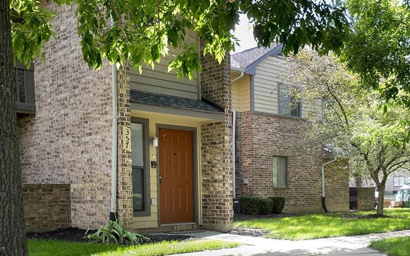 a brick house with a brown door