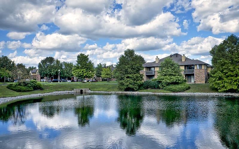 a pond in front of a house