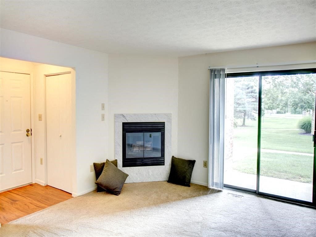 a living room with a fireplace and a sliding glass door